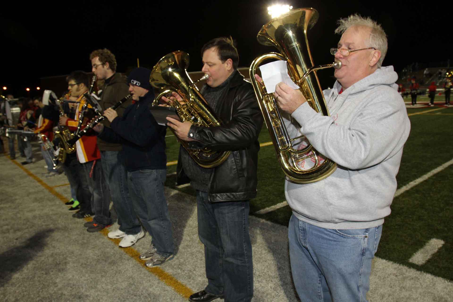 alumni-people-playing-instruments-outside-night-time